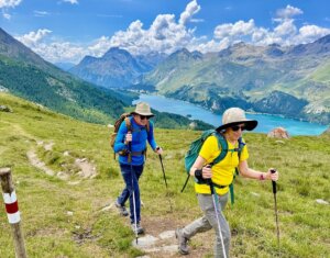 two hikers with a lake and mountains