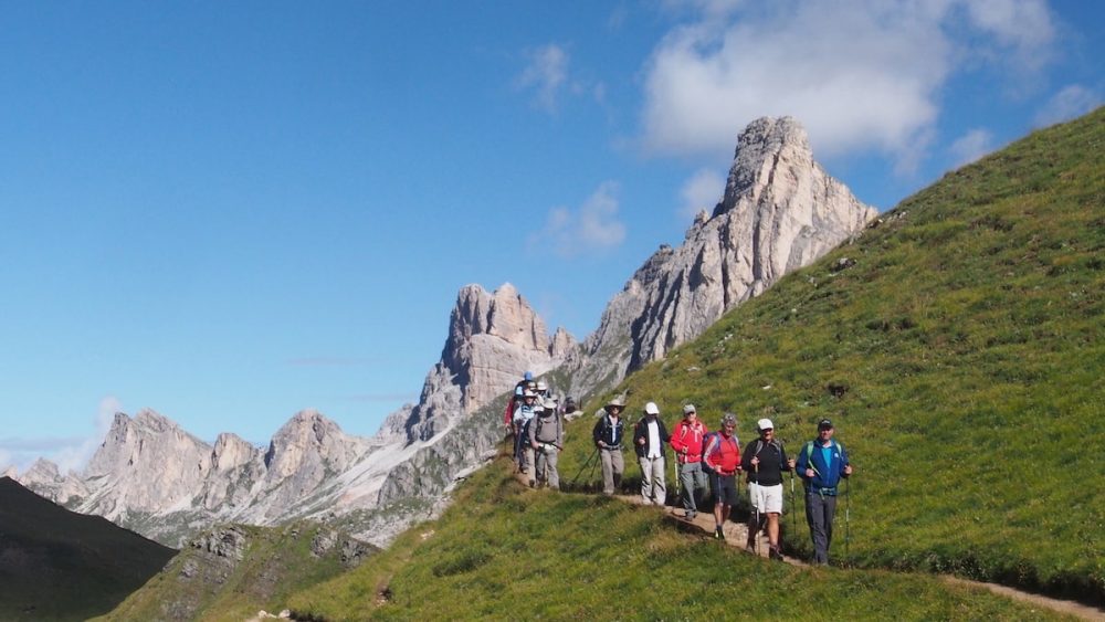 A group hiking along a green mountain trail