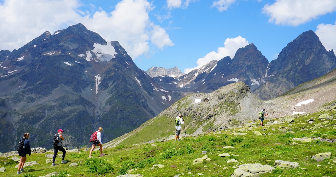 A group of hikers traversing through the Swiss National Park.