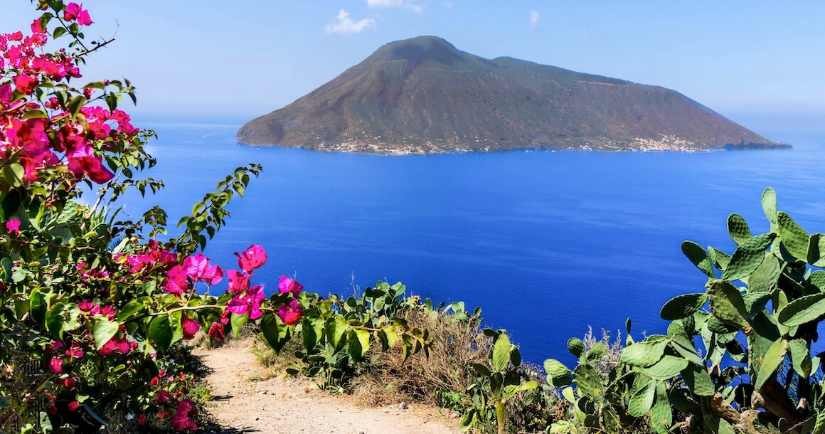 The blue sea separates a hiking path and island