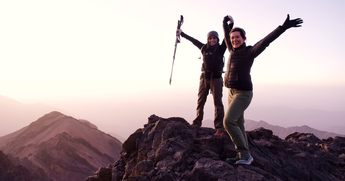 Two hikers on the summit celebrating