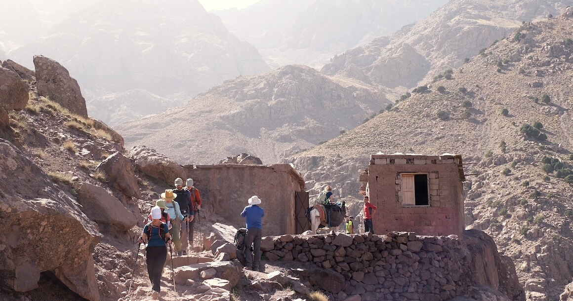 A group of hikers passes through a village