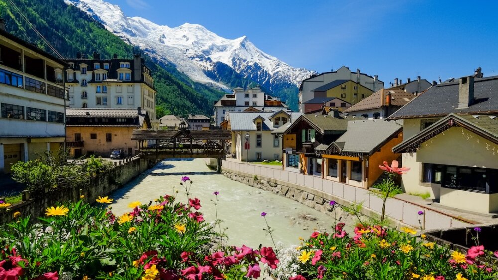 The river flowing through Chamonix with flowers in the foreground.