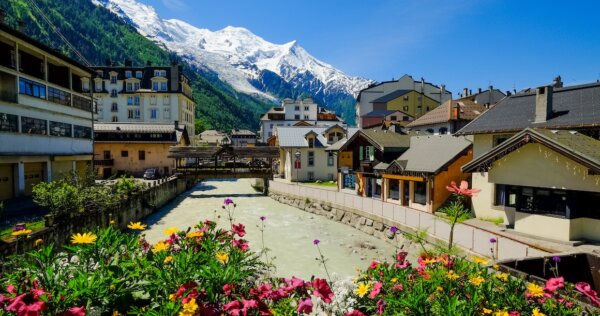 The river flowing through Chamonix with flowers in the foreground.