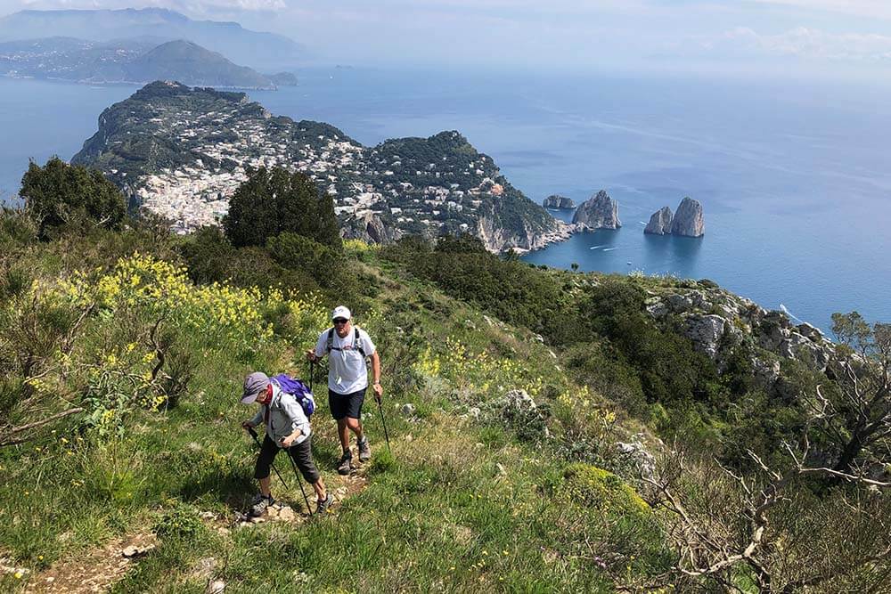 Hikers hiking a trail in Capri, Italy