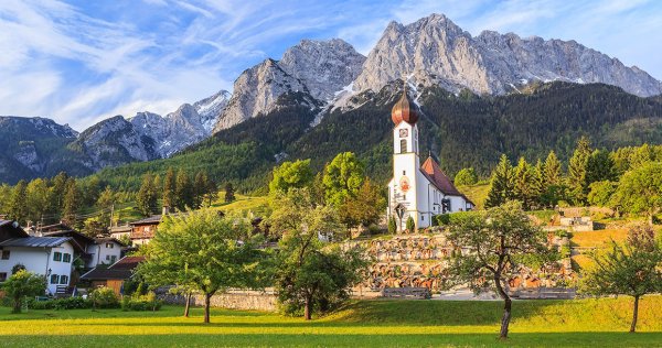An onion-domed church in front of Germany's highest peak, the Zugspitze.