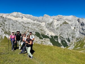 group hiking with dramatic mountains in the background