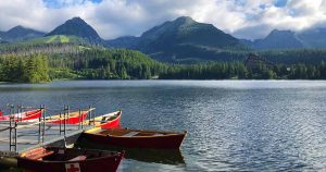 boats on a lake with a mountain in the background