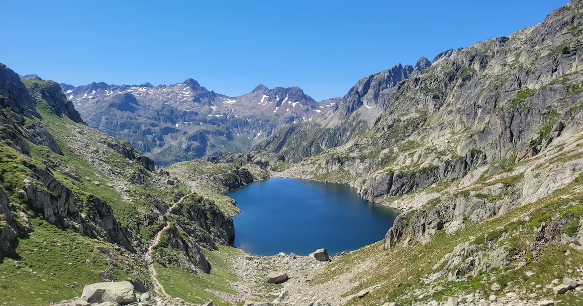 A dark blue lake in the middle of rocky mountains.