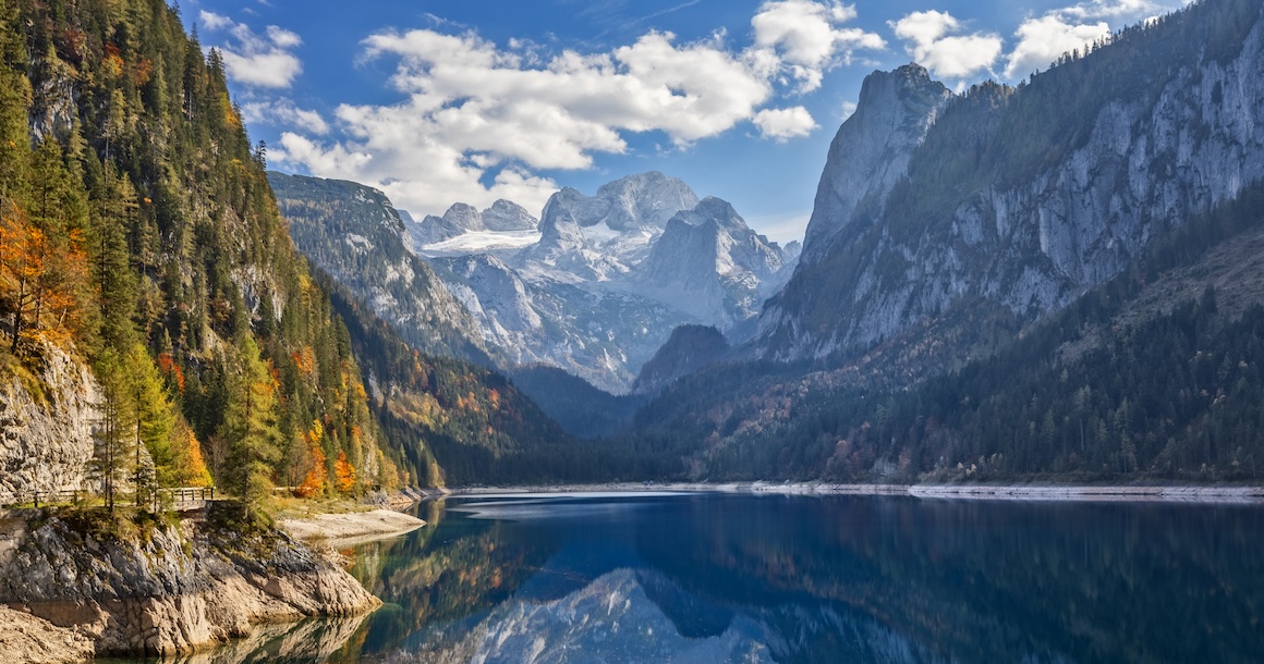 View of idyllic colorful autumn scenery with Dachstein mountain at lake Gosau