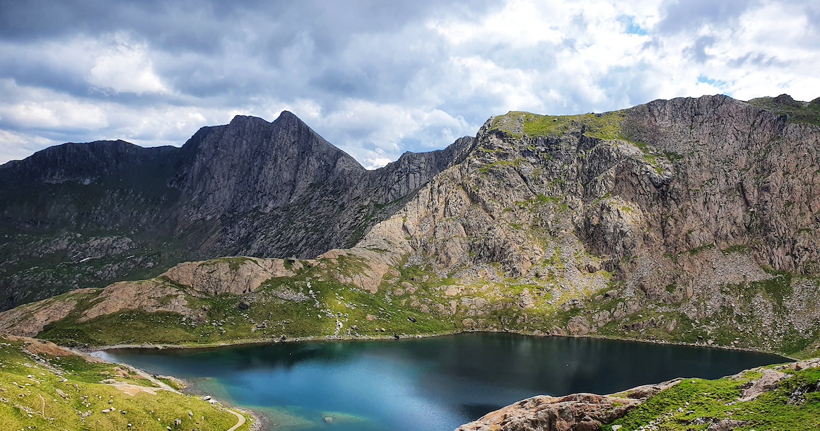 A beautiful lake with a jagged mountain behind it