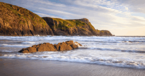Beach in Wales with rugged cliffs