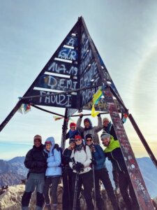hikers summit a mountain in morocco