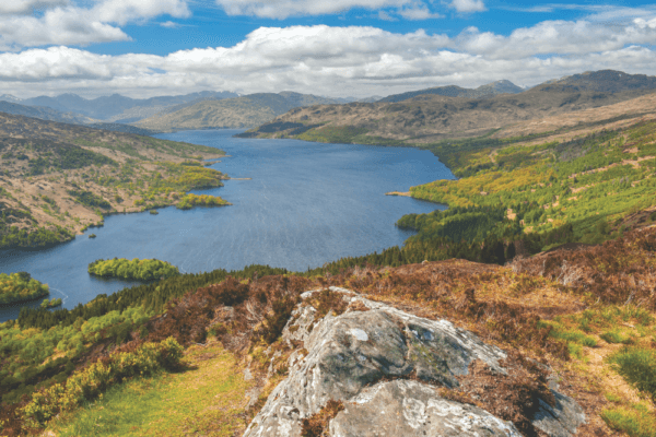 Rock overlooking bay on Rob Roy Way trek
