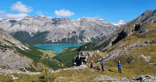 A group of hikers in the Ortler Alps above high alpine lake