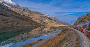 Train passing Lake Bianco in Italy