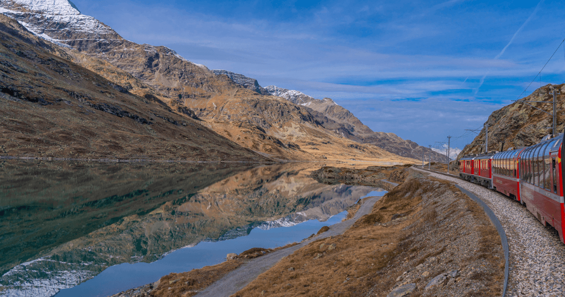 Train passing Lake Bianco in Italy